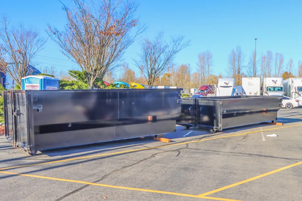 Professional dumpster rental service with roll-off container on residential driveway in Malden